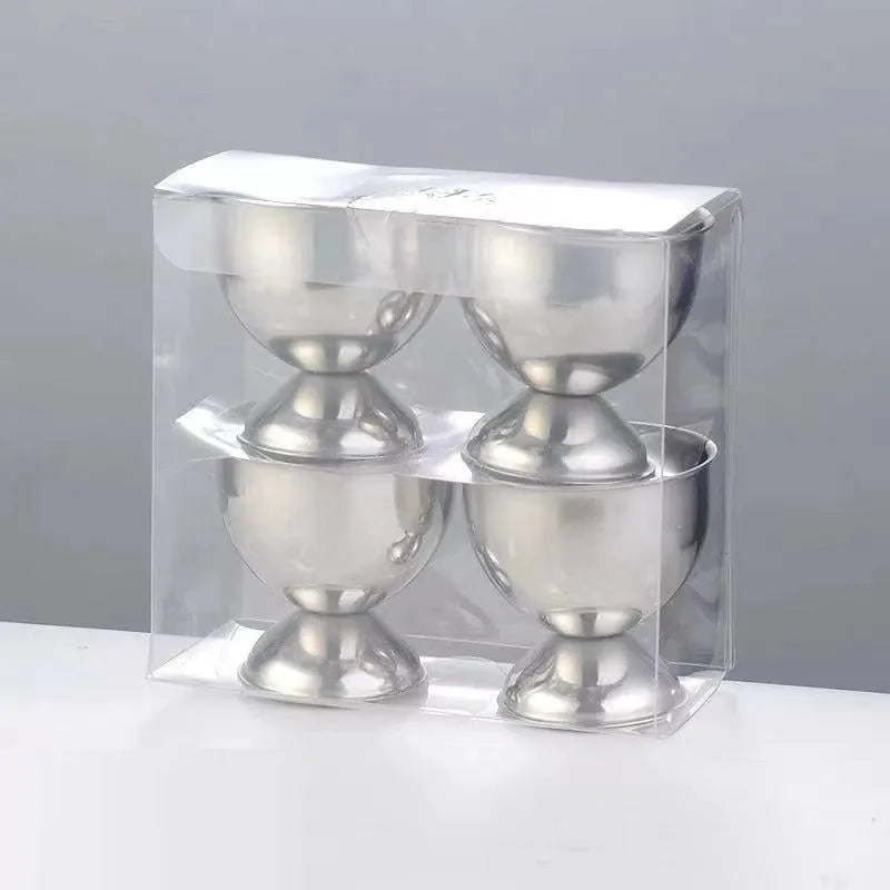 Creative stainless steel egg bracket in silver finish, holding eggs on a kitchen countertop.