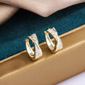 Geometric copper stud earrings with zircon detailing in 14K yellow gold colour