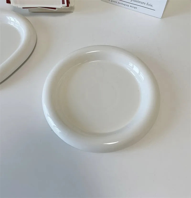 White porcelain plate with bear doodle design, shown as a plant pot tray.
