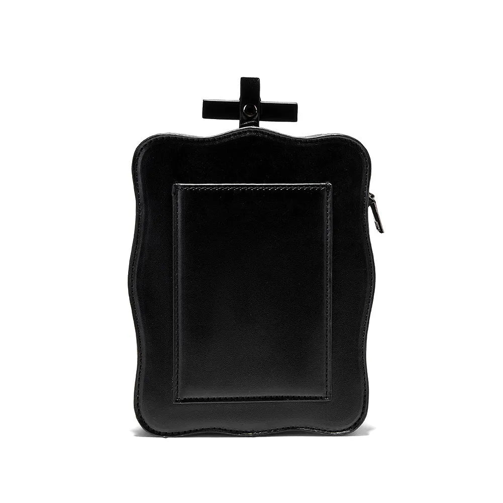 Black mini skull shoulder bag with 3D embossed design, chain strap, and vertical square shape for Gothic fashion.