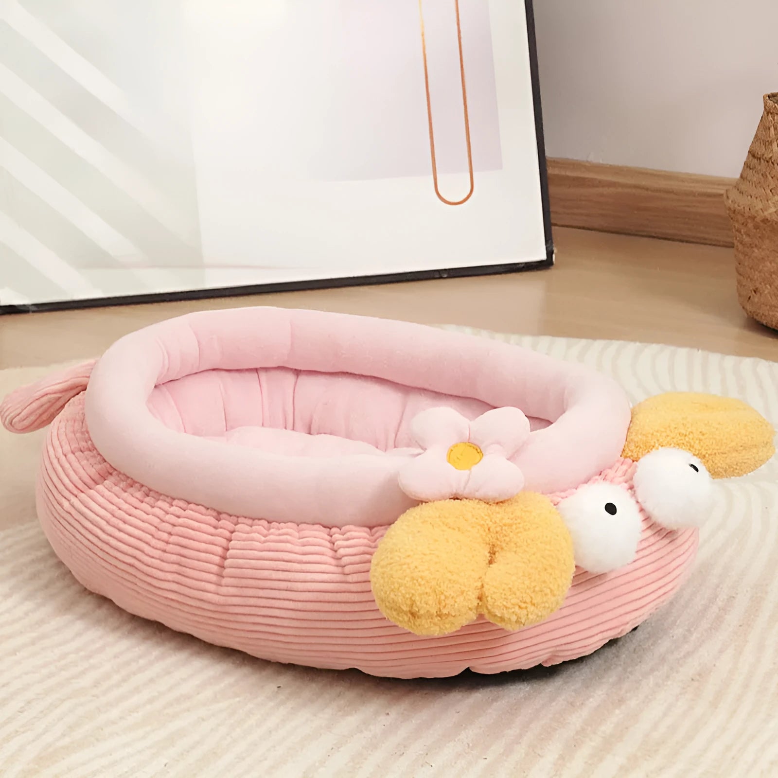 Pink semi-enclosed lobster pet nest with teddy fleece interior and non-slip base on a wood floor