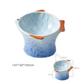 Blue fish-shaped ceramic cat bowl with tilted angle and elevated base on a table.