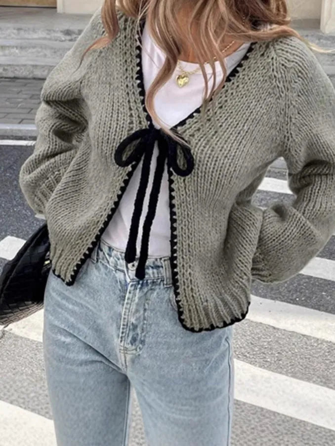 Grey lace-up sweater cardigan with long sleeves and crocheted flower decoration on the front.