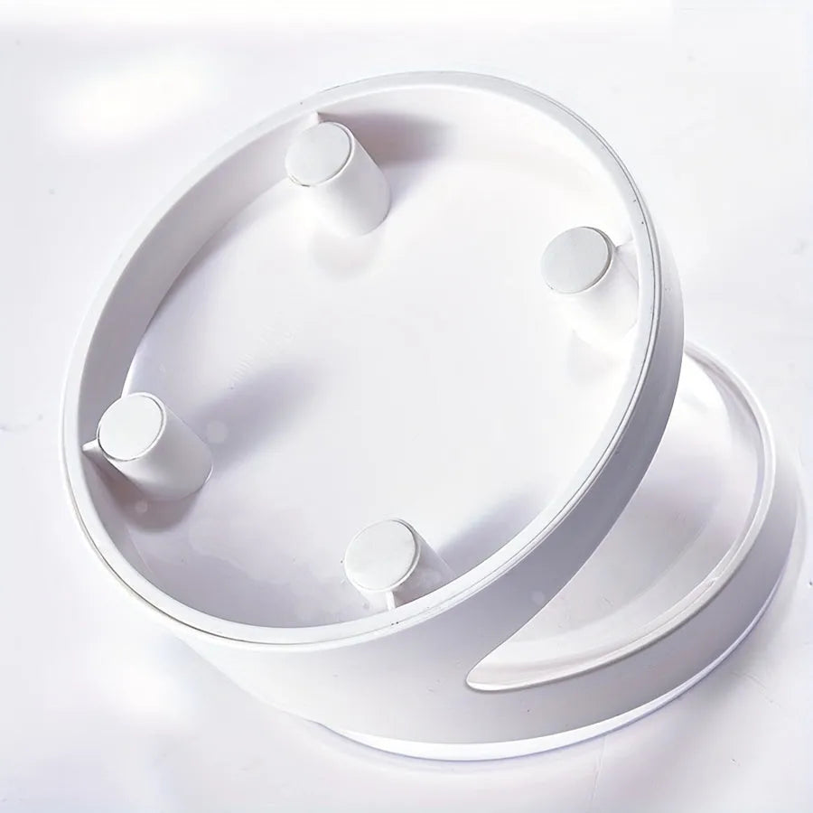 White elevated tilted plastic cat food bowl on a flat surface