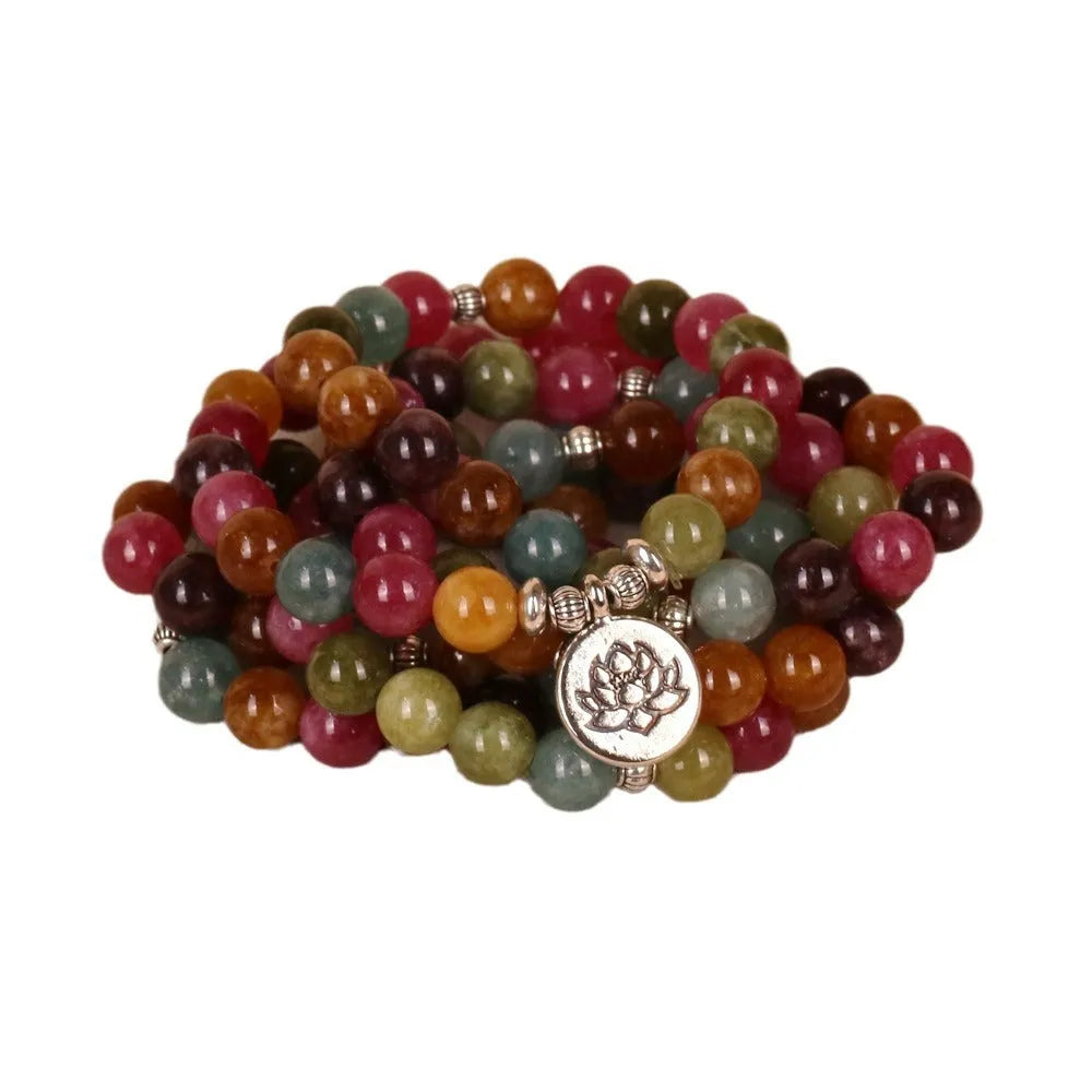 108 bead multi-layer bracelet with lotus charm in tourmaline colour on wrist
