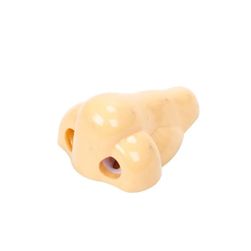 Flesh colour plastic pencil sharpener showing geometry shape and big nostril opening