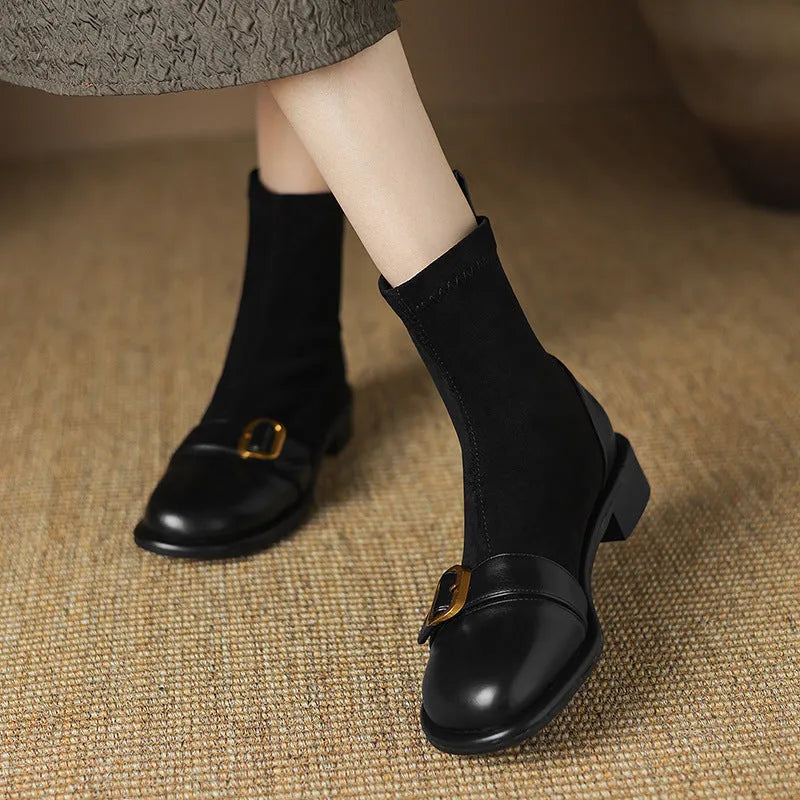 Women's black low heel lace-up Martin boots with round toe and rubber sole.