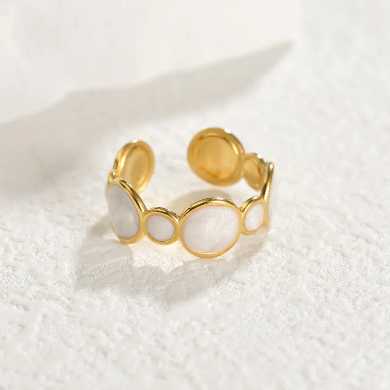 A geometric stainless steel ring with an adjustable opening and an electroplated finish.