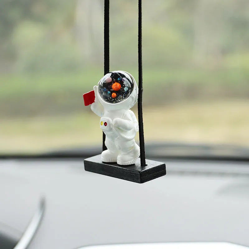 Resin astronaut car pendant with cartoon space explorer designs including telescope and radish variations