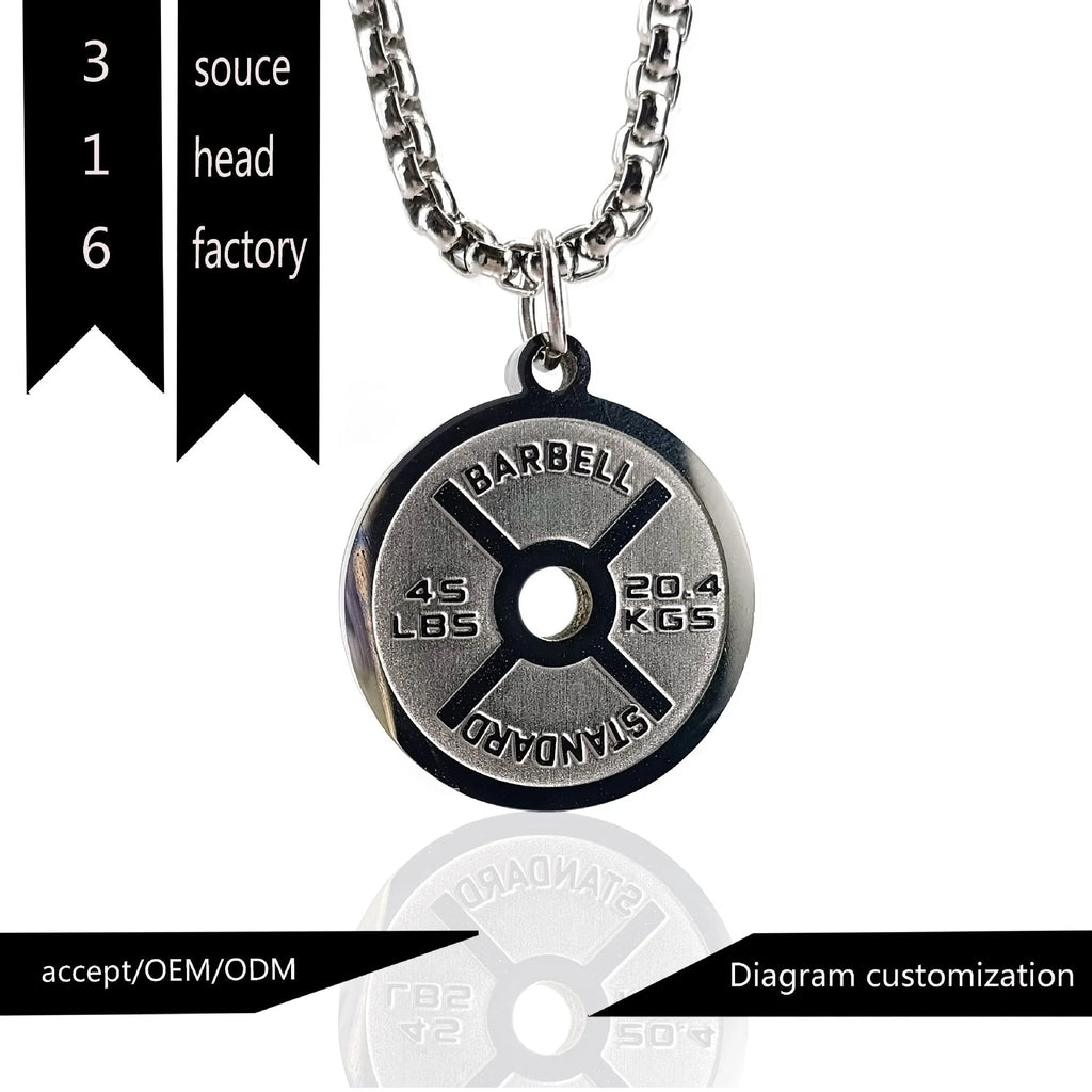 Polished stainless steel barbell disk geometric pendant necklace on a gold chain.