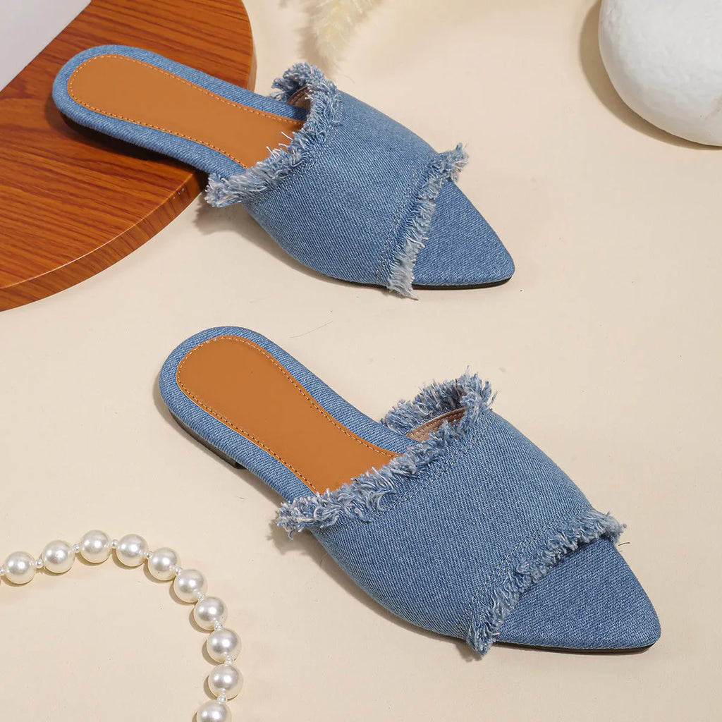 Women's denim flat slippers with tassel decoration and leather lining in apricot colour.