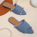 Women's denim flat slippers with tassel decoration and leather lining in apricot colour.