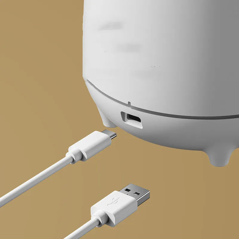White Huoyanshan volcanic-shaped ultrasonic humidifier and aromatherapy diffuser on a table.