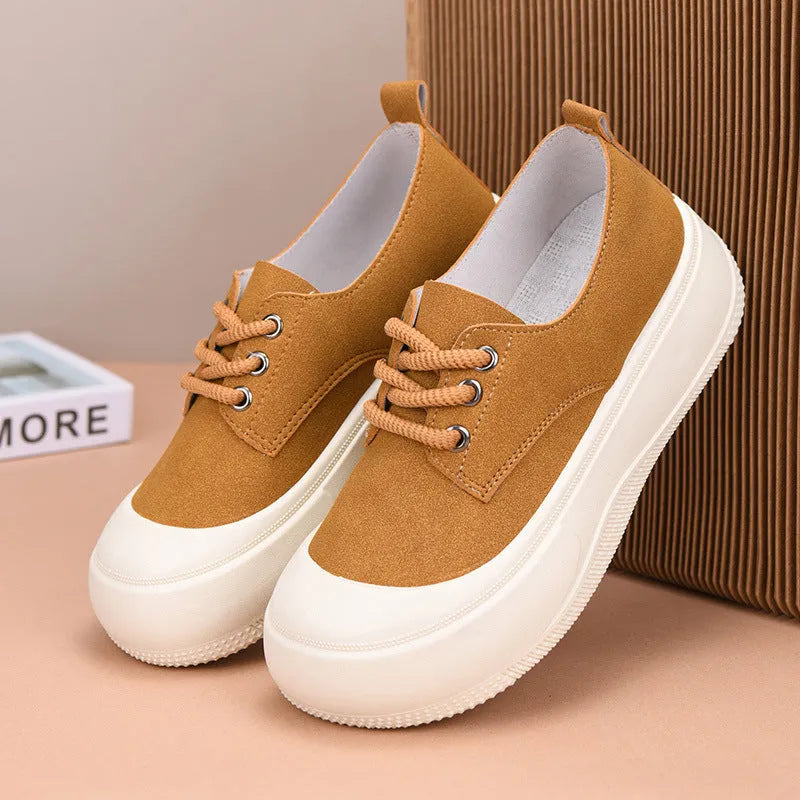 Women's beige suede platform loafers with round toe and front lace-up, on a white background.