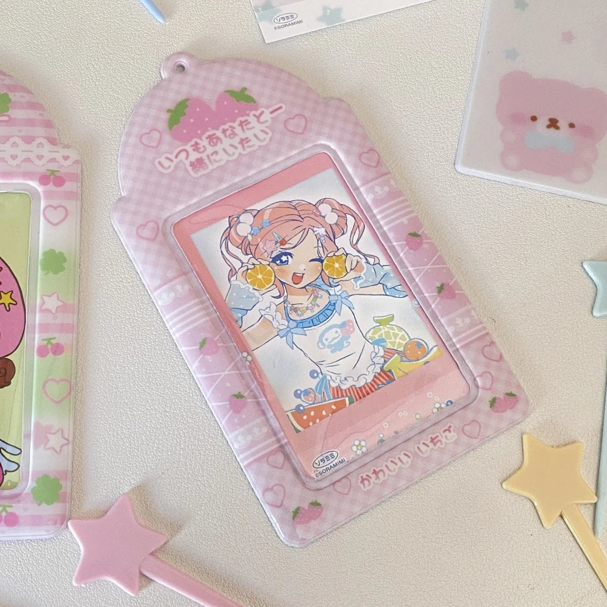 Cartoon plaid PVC card holder pendant in strawberry and four-leaf clover styles for 3-inch cards.