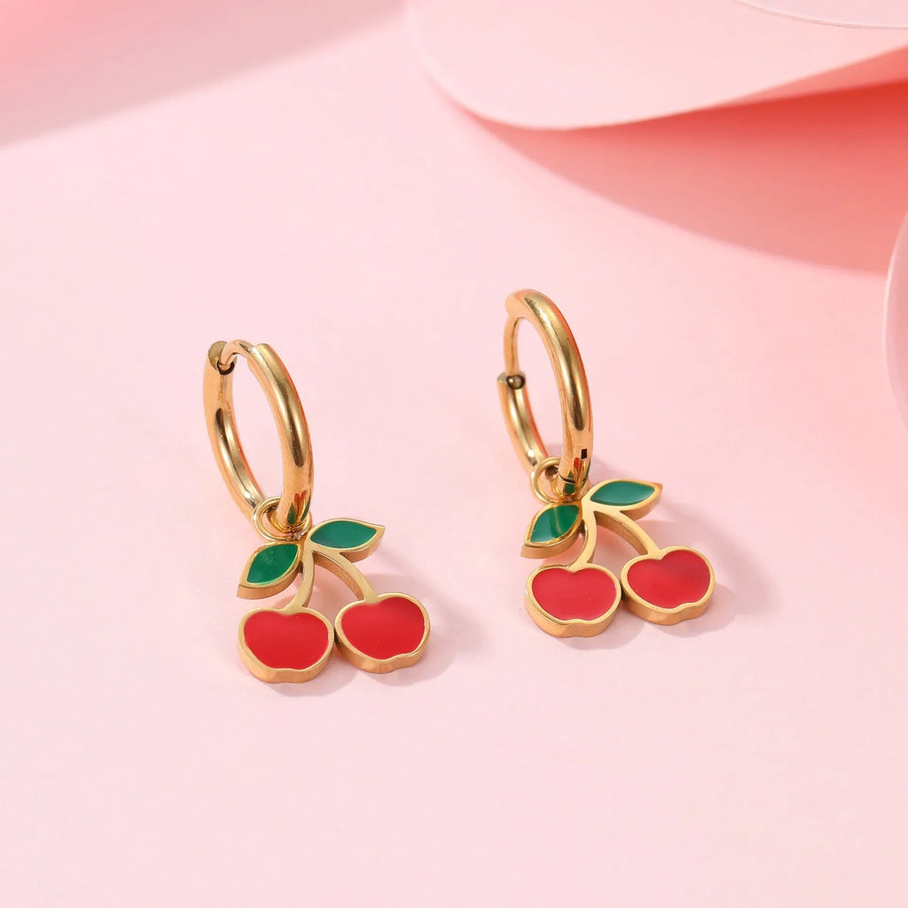 Complete cherry jewellery set showing stainless steel necklace, bracelet, earrings, and ring pieces with electroplated colour finishes
