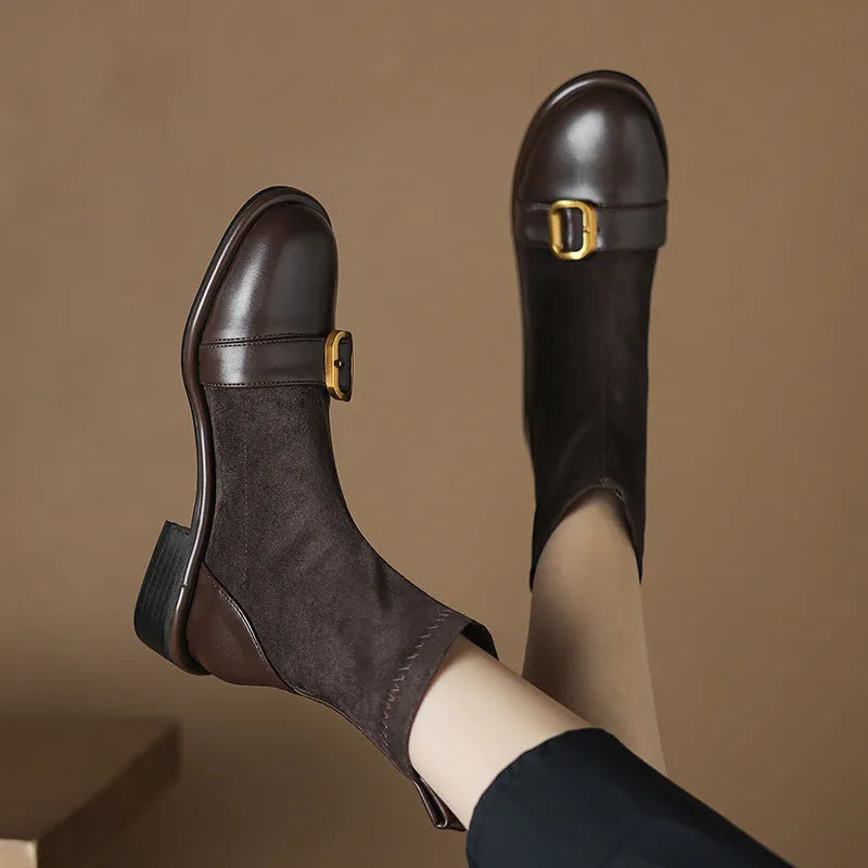 Women's black low heel lace-up Martin boots with round toe and rubber sole.