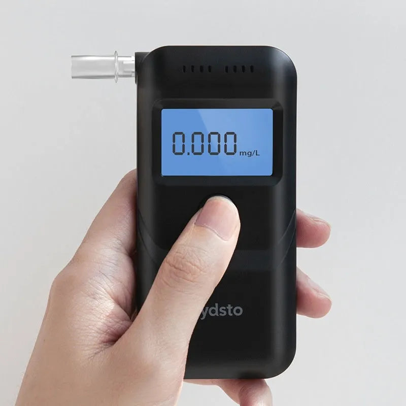 Black household alcohol tester with digital display for breath checking