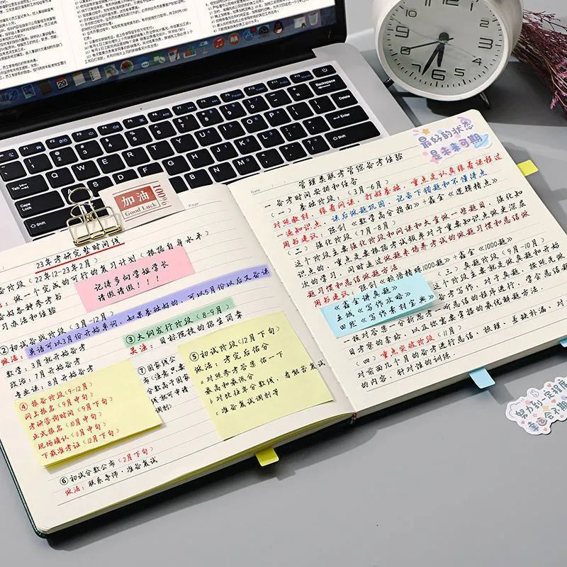 Square faux leather notebook open on a desk, showing flat French fold binding and Daolin paper.