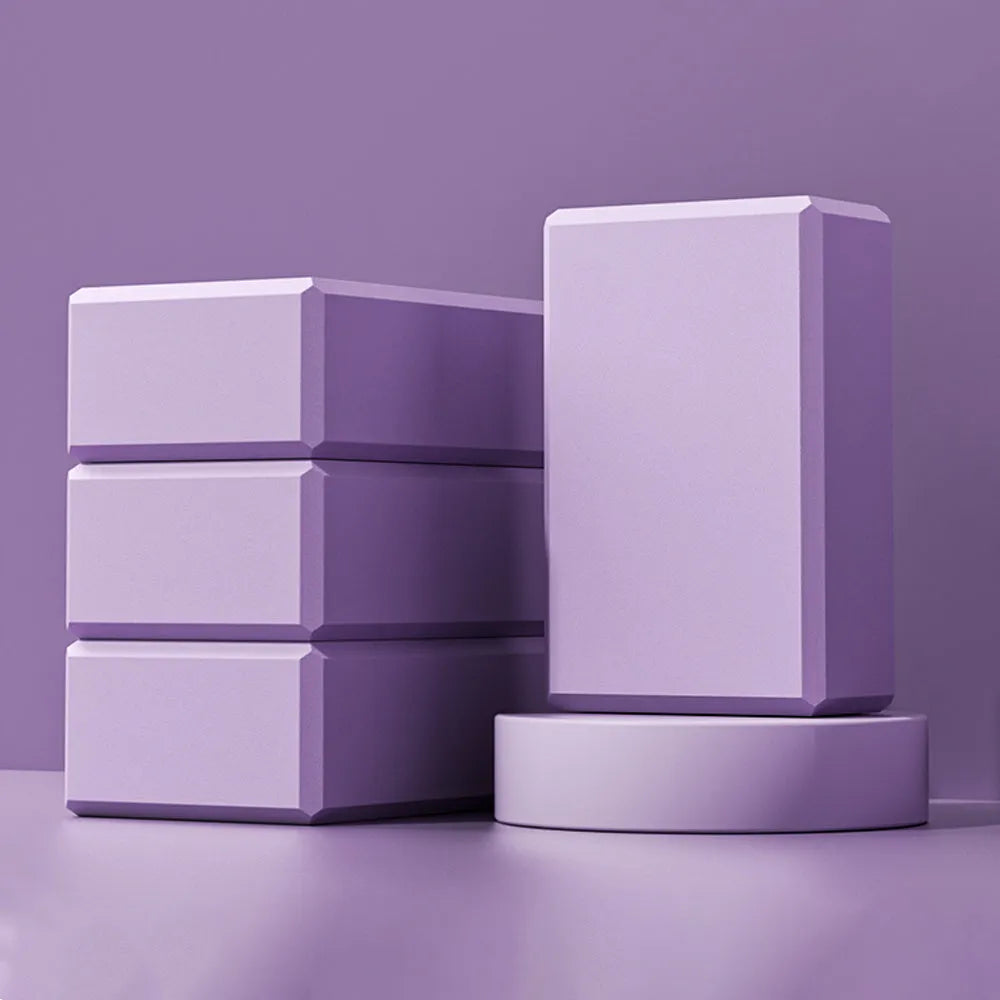Solid colour EVA foam yoga block with hexagonal ridges, shown next to tape measure showing 23cm length