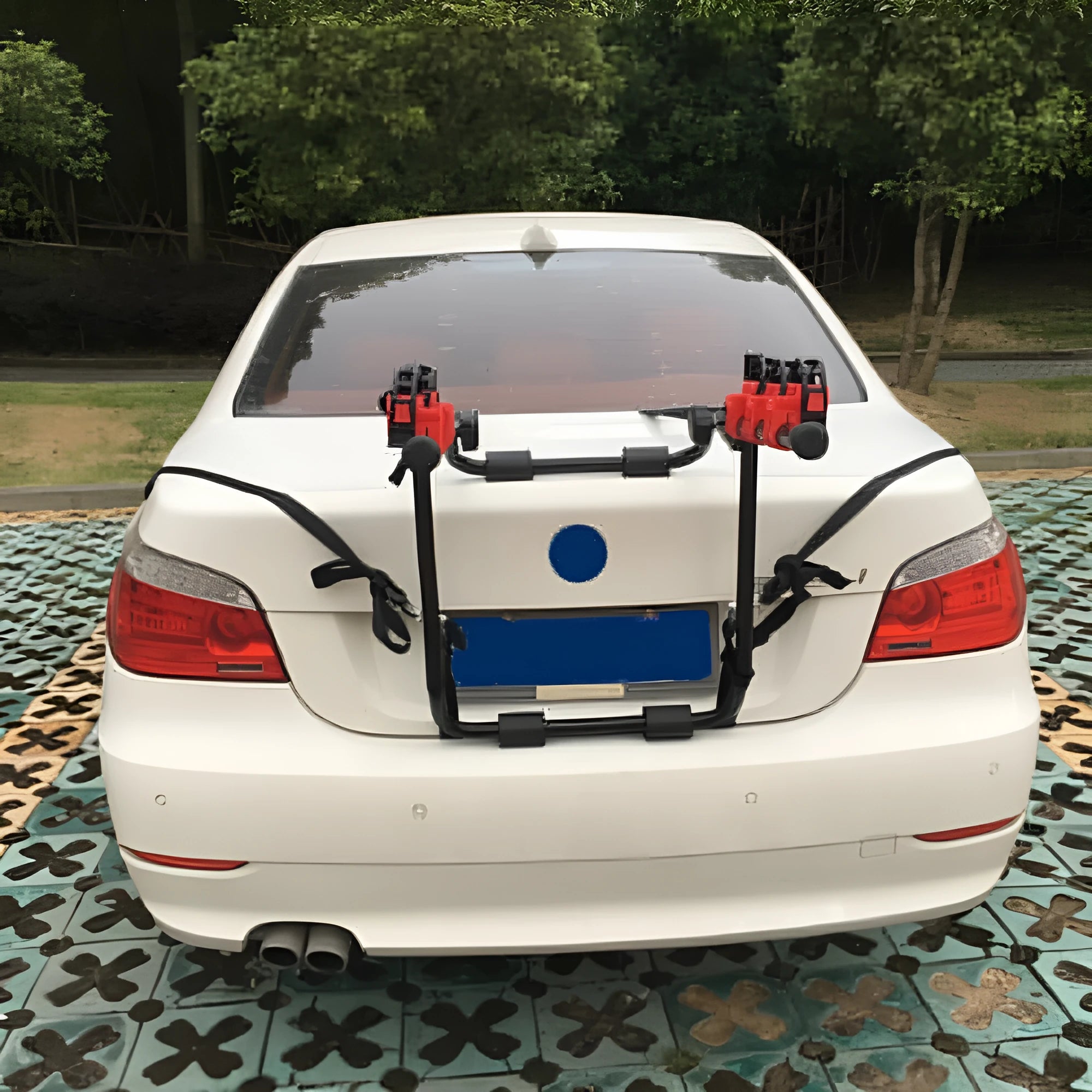 Black and red trunk mounted car bike holder rack showing rope tie and pull belt fastening options.