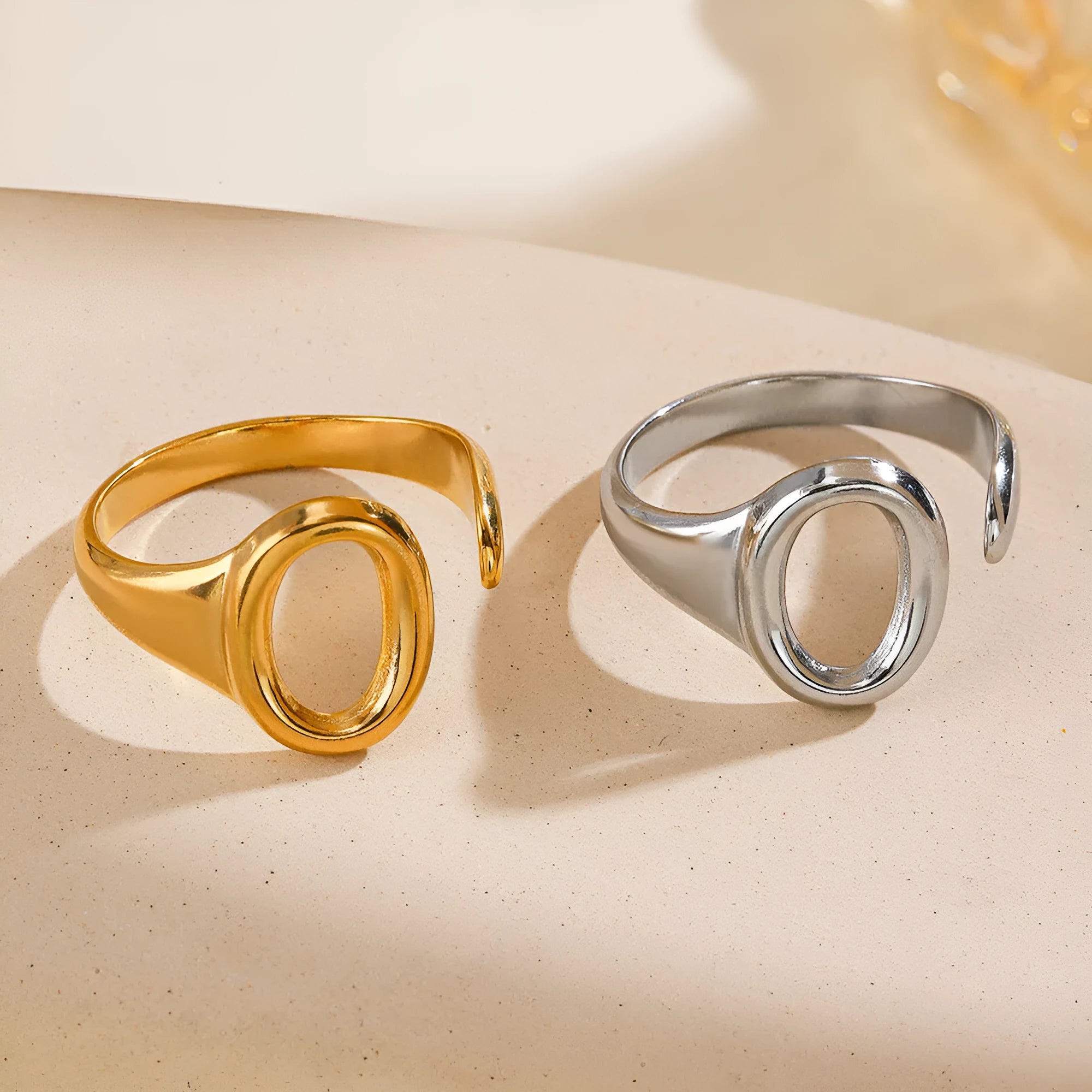 Oval ins style adjustable stainless steel ring in gold and steel colours on white background