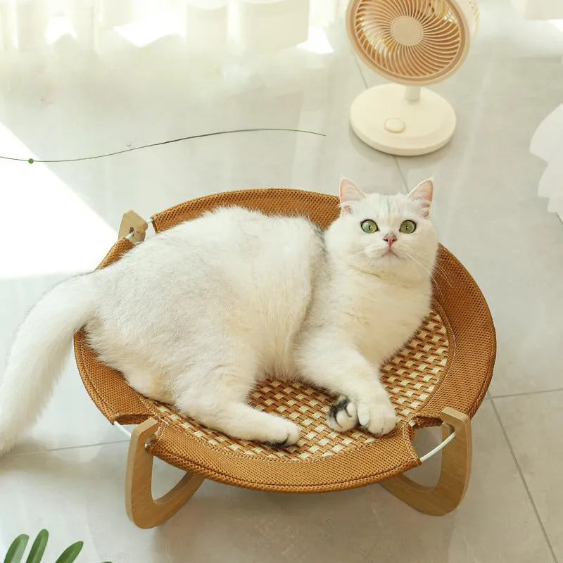Brown woven rattan square pet bed basket for cats and small dogs on a wooden floor.