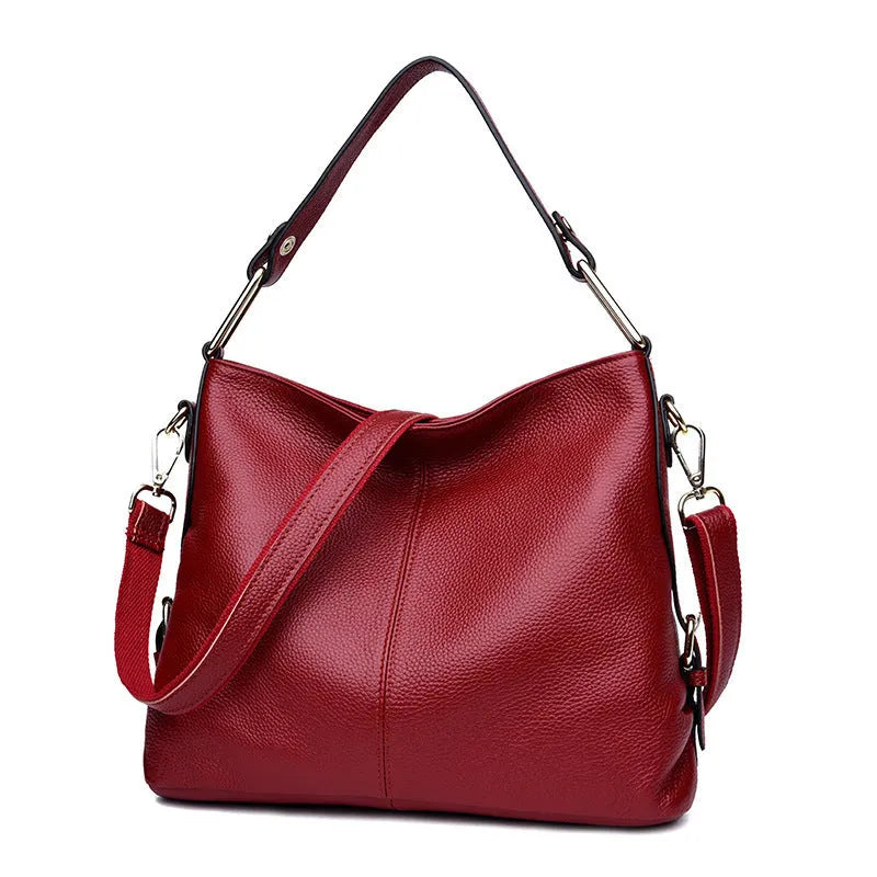 Genuine leather vertical square crossbody bag in black colour with visible stitching and multiple compartments.
