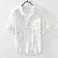 Men's loose fit short-sleeved polo shirt in white or black with traditional collar