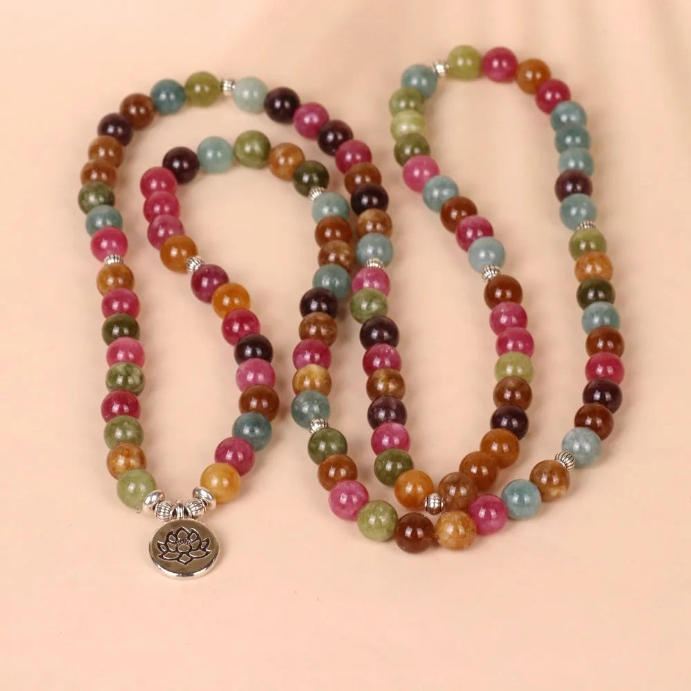 108 bead multi-layer bracelet with lotus charm in tourmaline colour on wrist