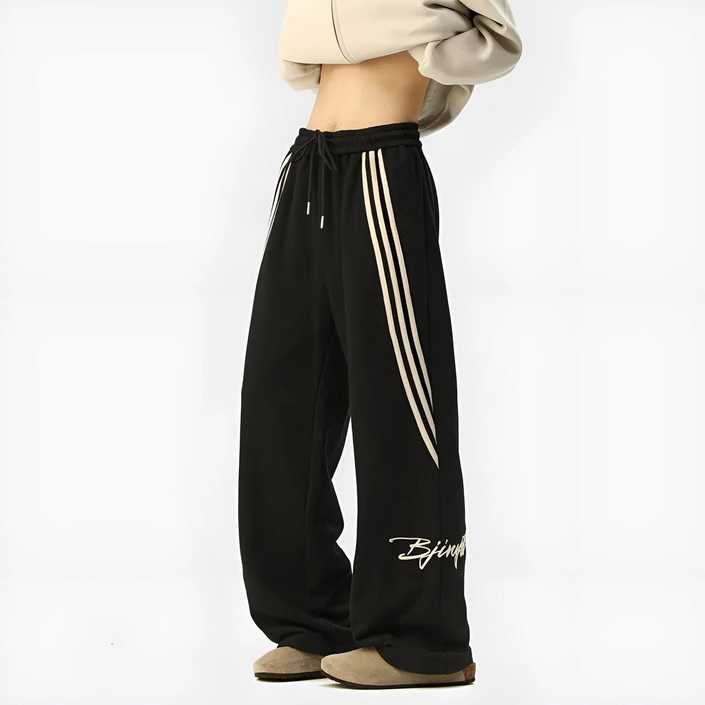 Men's striped loose straight-leg casual pants in Black, front view, showing wrinkle-free fabric and straight leg cut