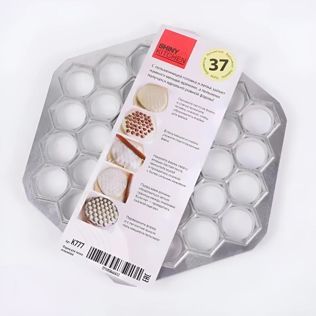 Silver aluminum alloy 37-hole dumpling mold on a plain background