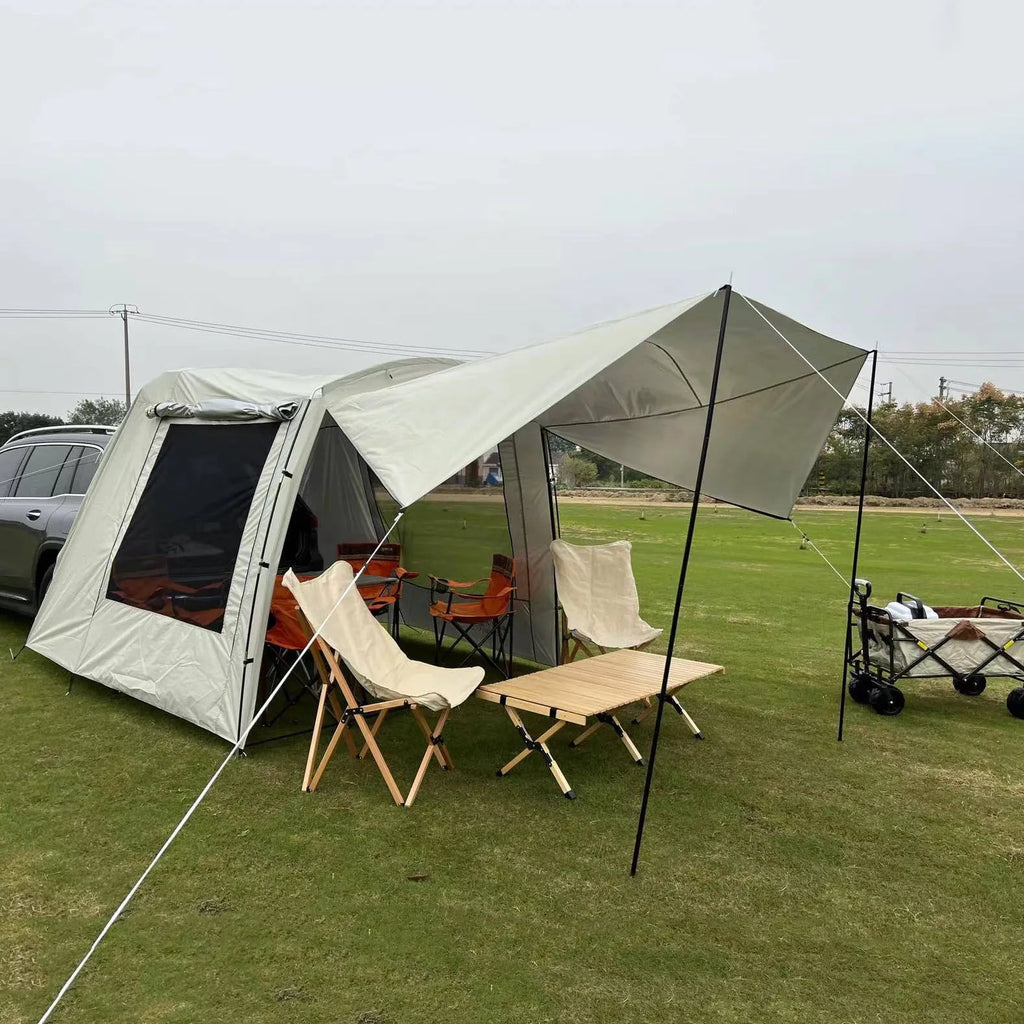 Car tail extension tent set up at a campsite with rear access, showing 190T silver-coated anti-UV fabric and screen windows.
