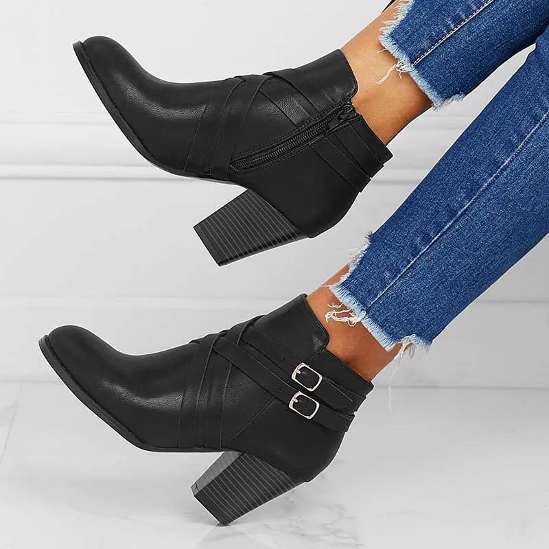 Women's short ankle boot with 7cm heel, side zipper, and belt buckle detail in grey.