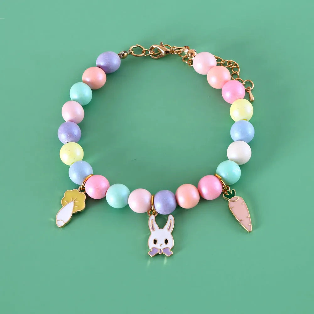 Colourful macaron-themed resin collar and bracelet set for pets on a pastel background.