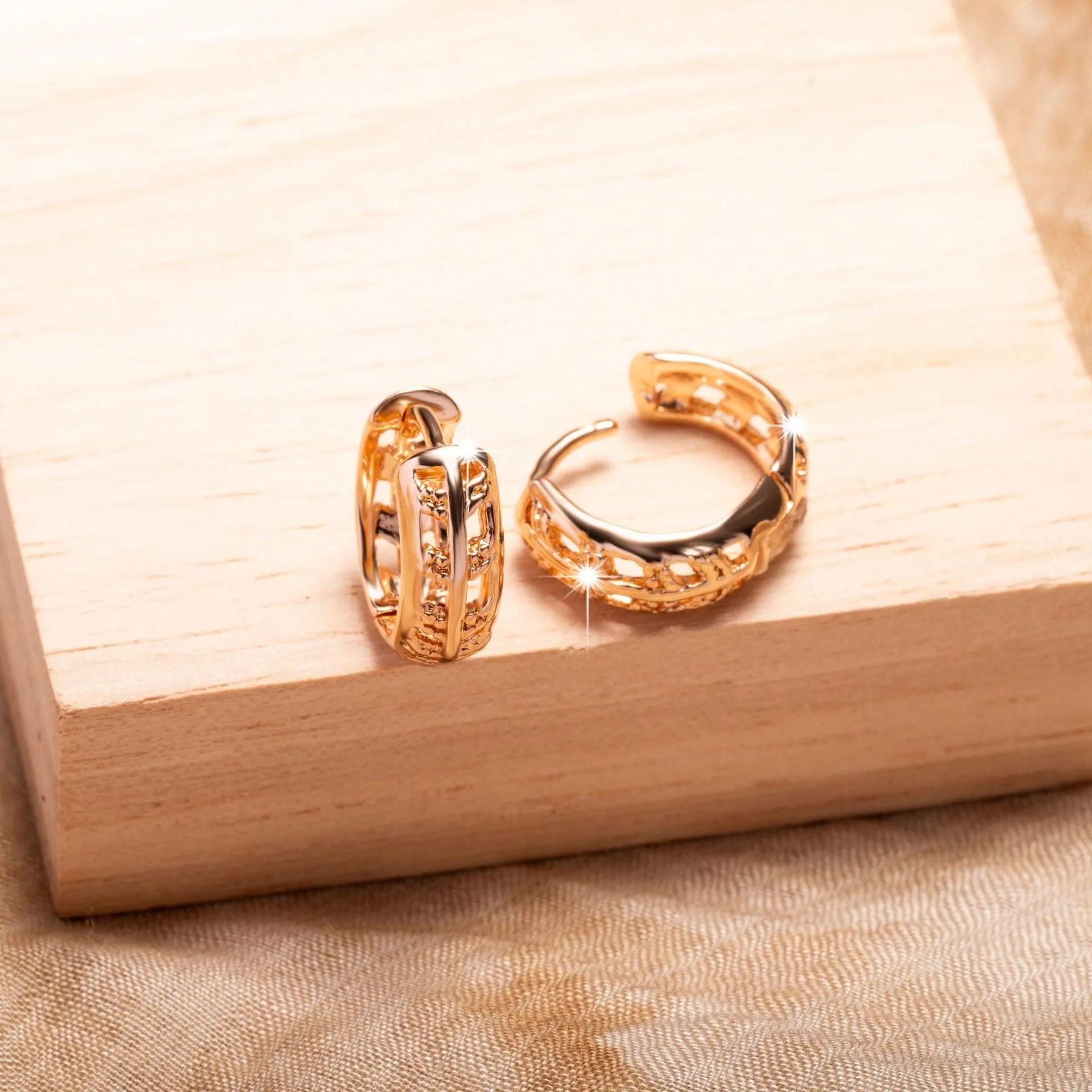 Hollowed-out copper earrings in heart and leaf shapes with a rose gold finish.