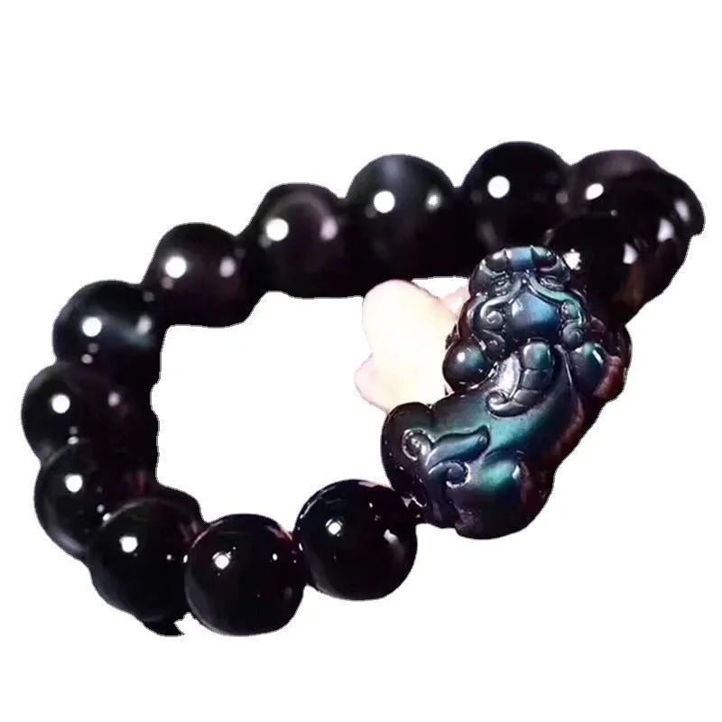 Natural ice colour Eye Obsidian crystal beaded bracelet on a wrist, showing clear spherical beads.
