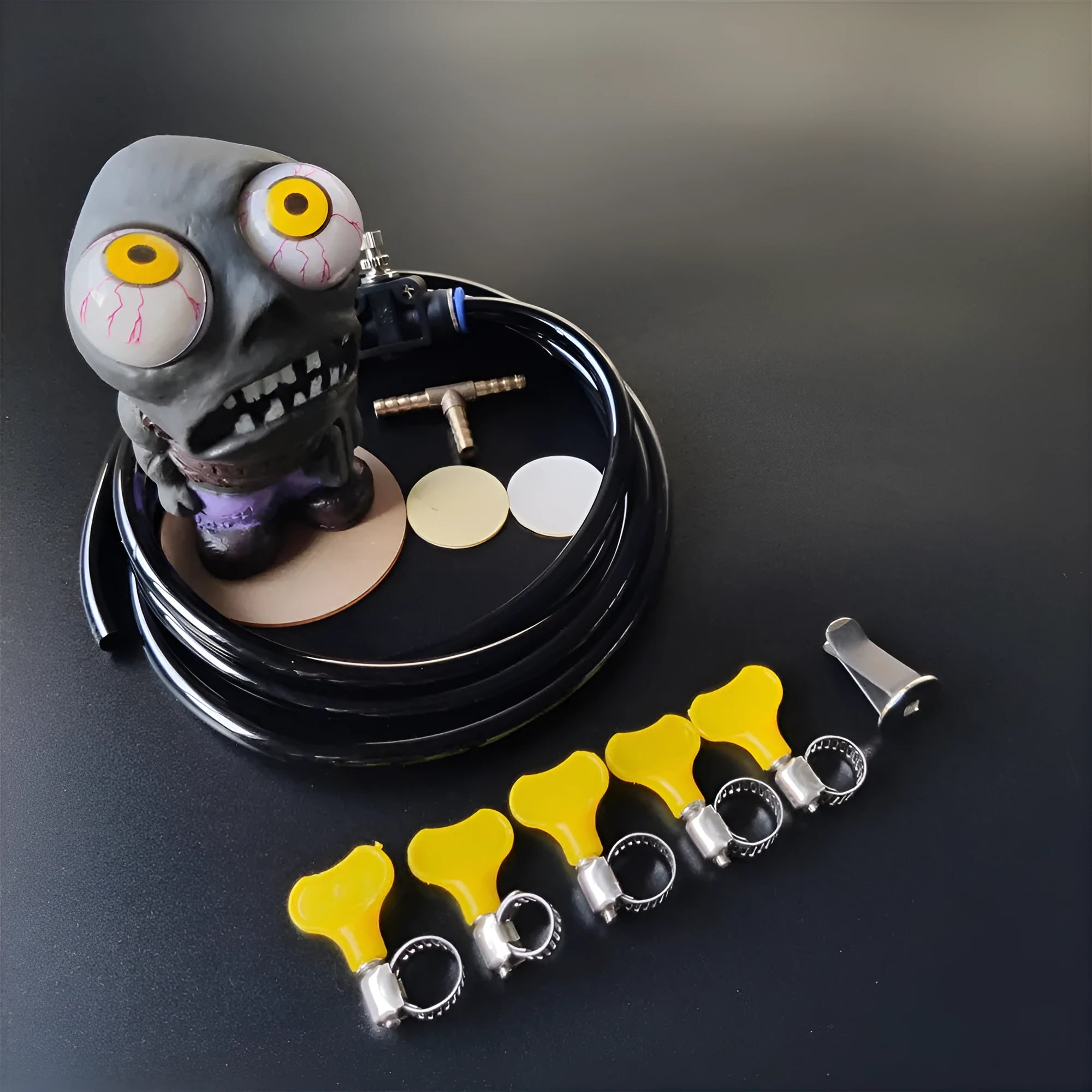 Turbo car blow-off valve ornament kit showing rubber doll, pressure valve, copper connectors and tubing