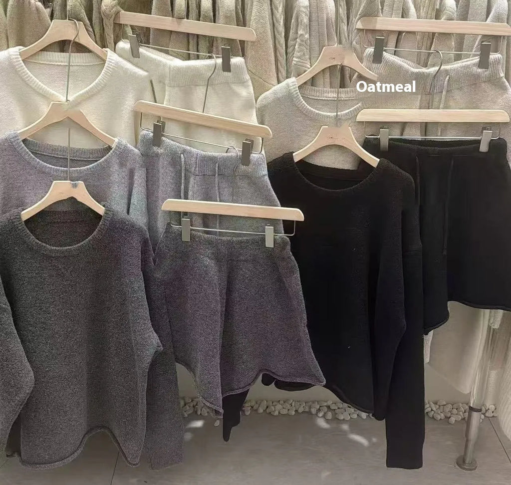 Women's loose-fitting knitted two-piece set showing long sleeve sweater and wide leg shorts in oatmeal colour