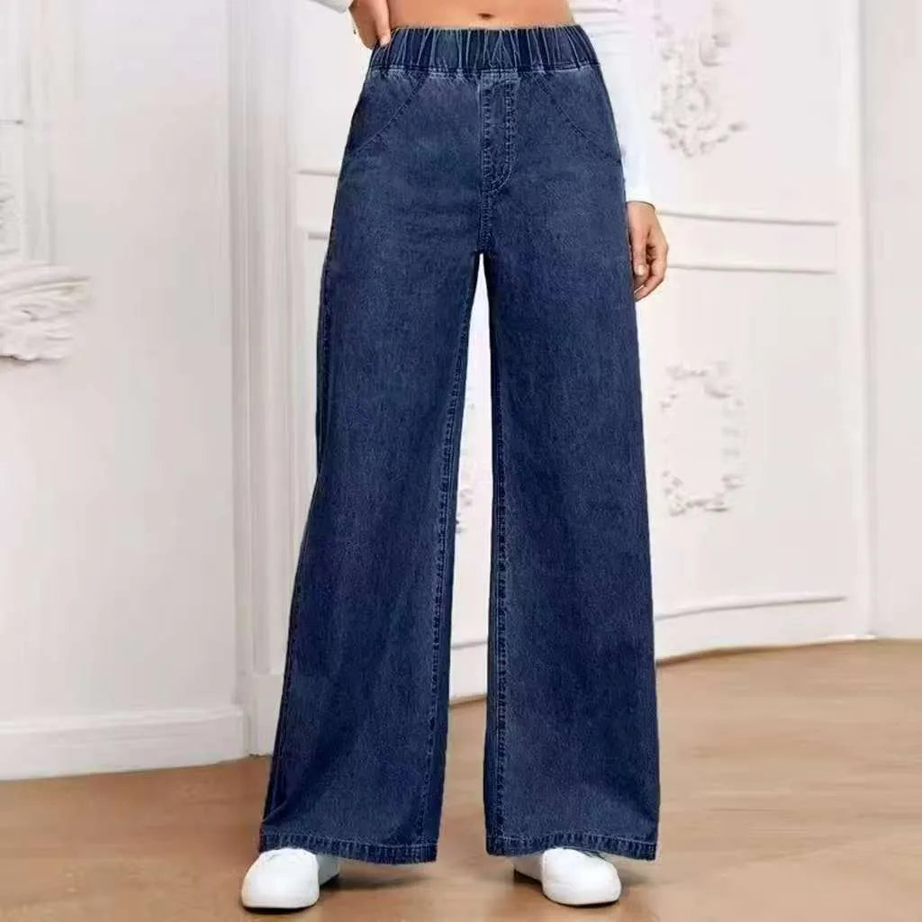 Light blue washed wide-leg straight jeans on a hanger, showing zip fly and mid-waist design.