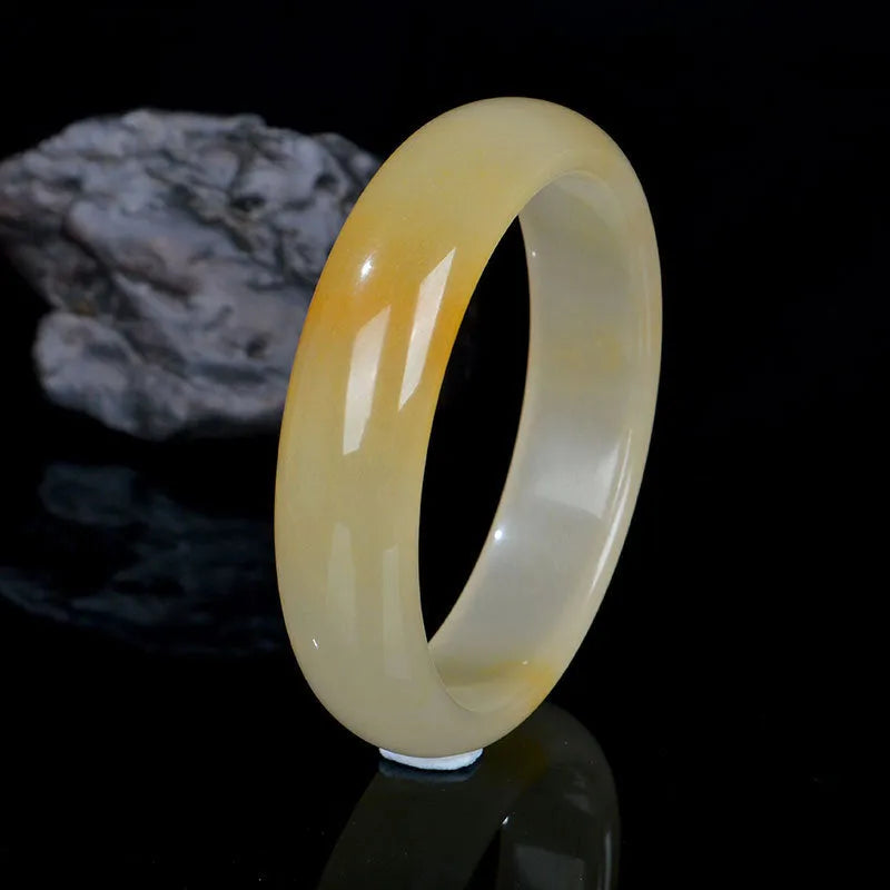 Natural gem light jade bracelet in Chinese style with polished surface showing traditional ornament form