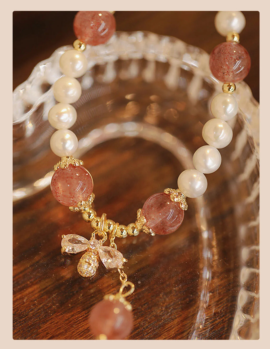 Women's hand-made strawberry quartz crystal bracelet with stringed pearls and bow detail