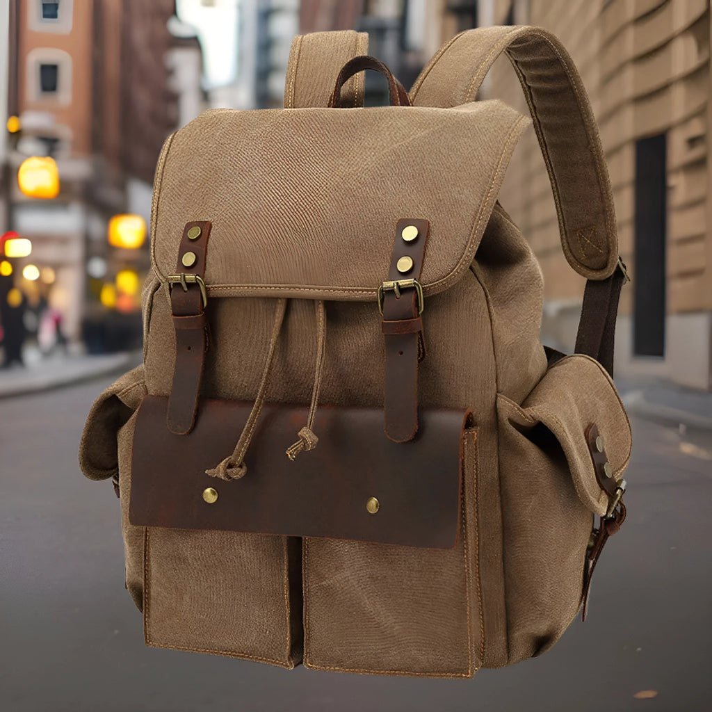 Retro canvas backpack in army green with antique bronze hardware showing dimensions and laptop compartment