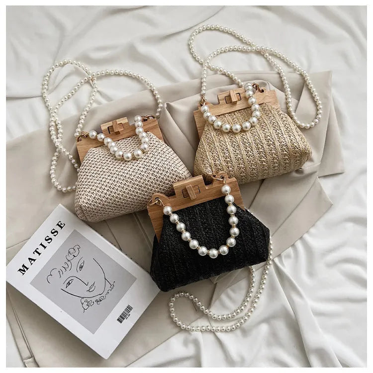 Women's woven straw shoulder bag with pearl chain details showing interior organisation compartments