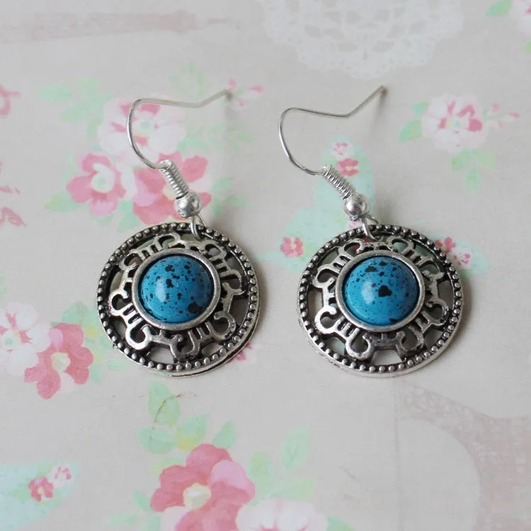 Handmade Tibetan silver earrings with turquoise geometric flower disk design in Miao ethnic style
