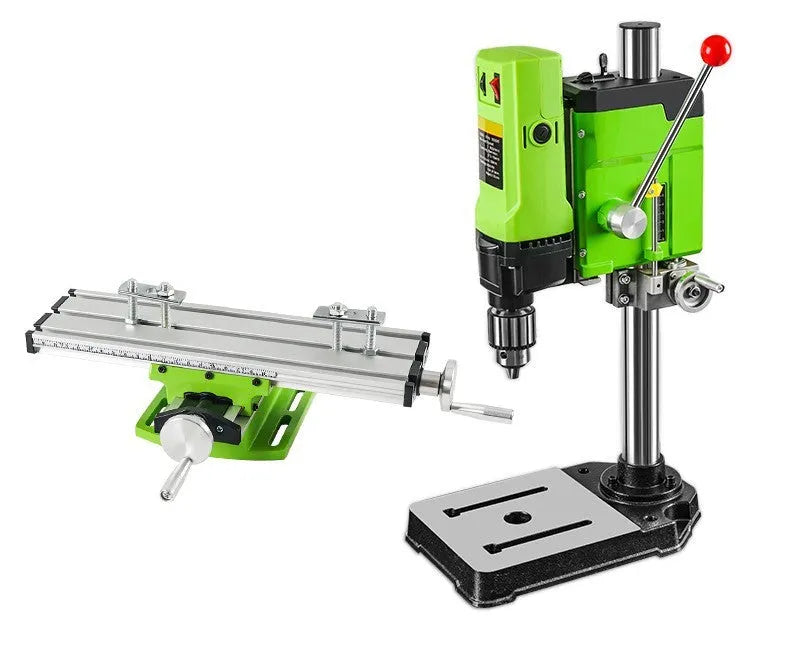Bench-mounted drilling and milling machine with motor, chuck, and adjustable work table.