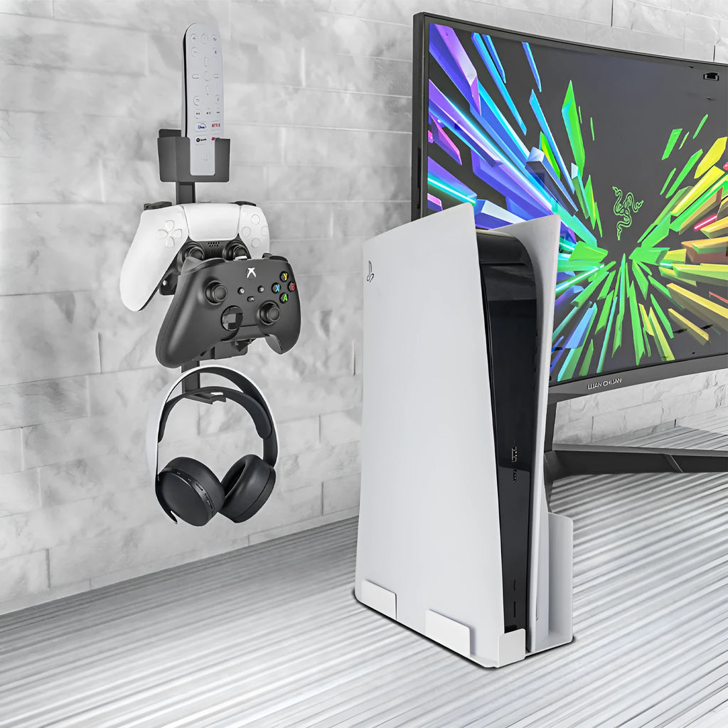 White wall-mounted plastic hook holding a black gaming controller and a headset.