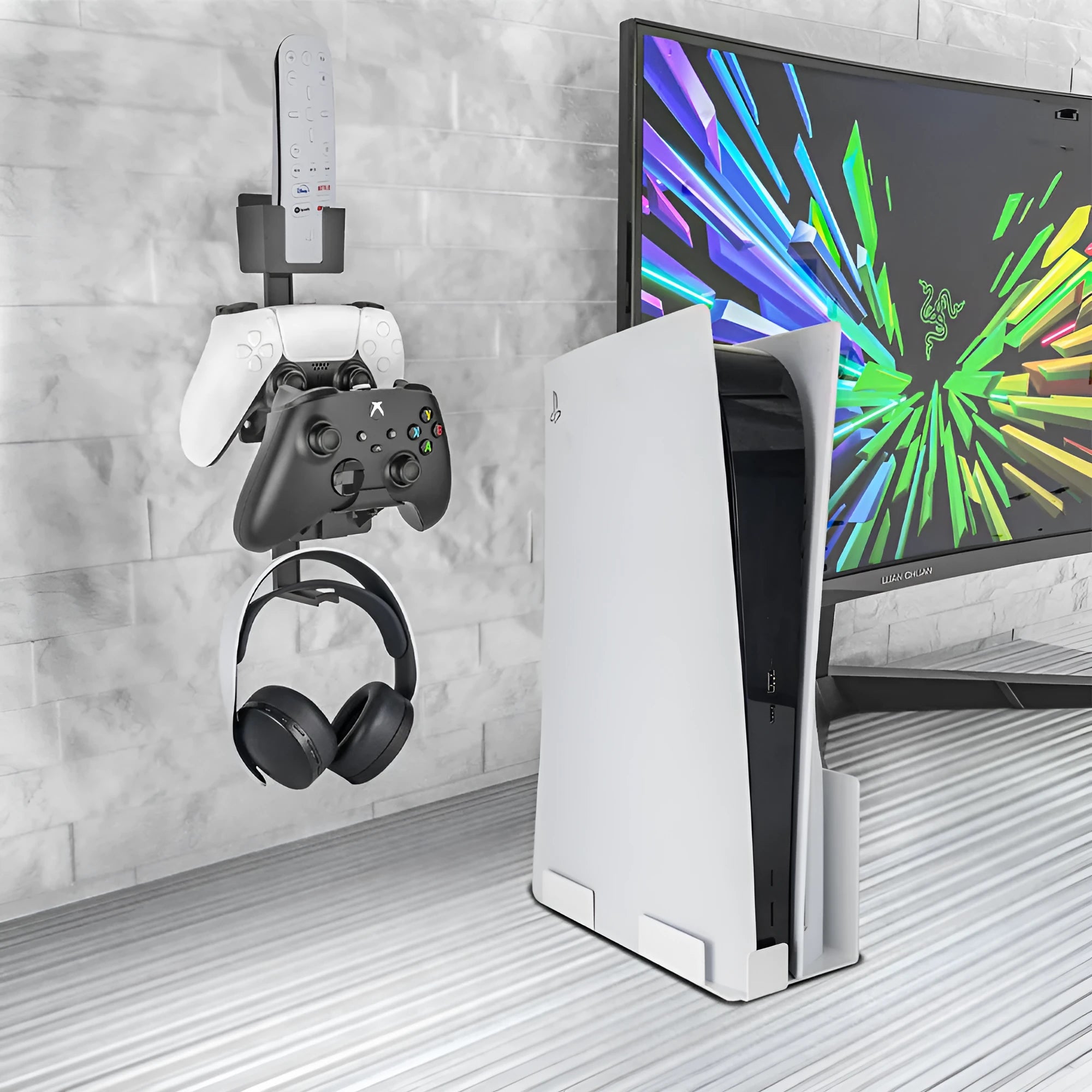 White wall-mounted plastic hook holding a black gaming controller and a headset.