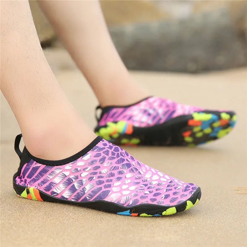 Men's and women's beach wading shoes in blue, with Lycra upper and EVA midsole, on a sandy background.