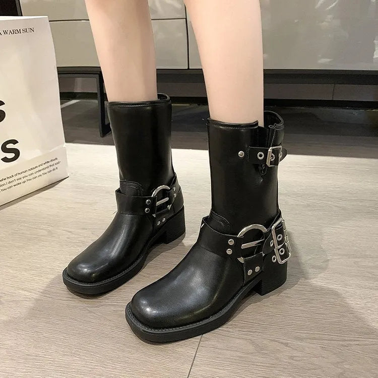 Black platform women's boot with a belt buckle on the shaft, mid-calf height.
